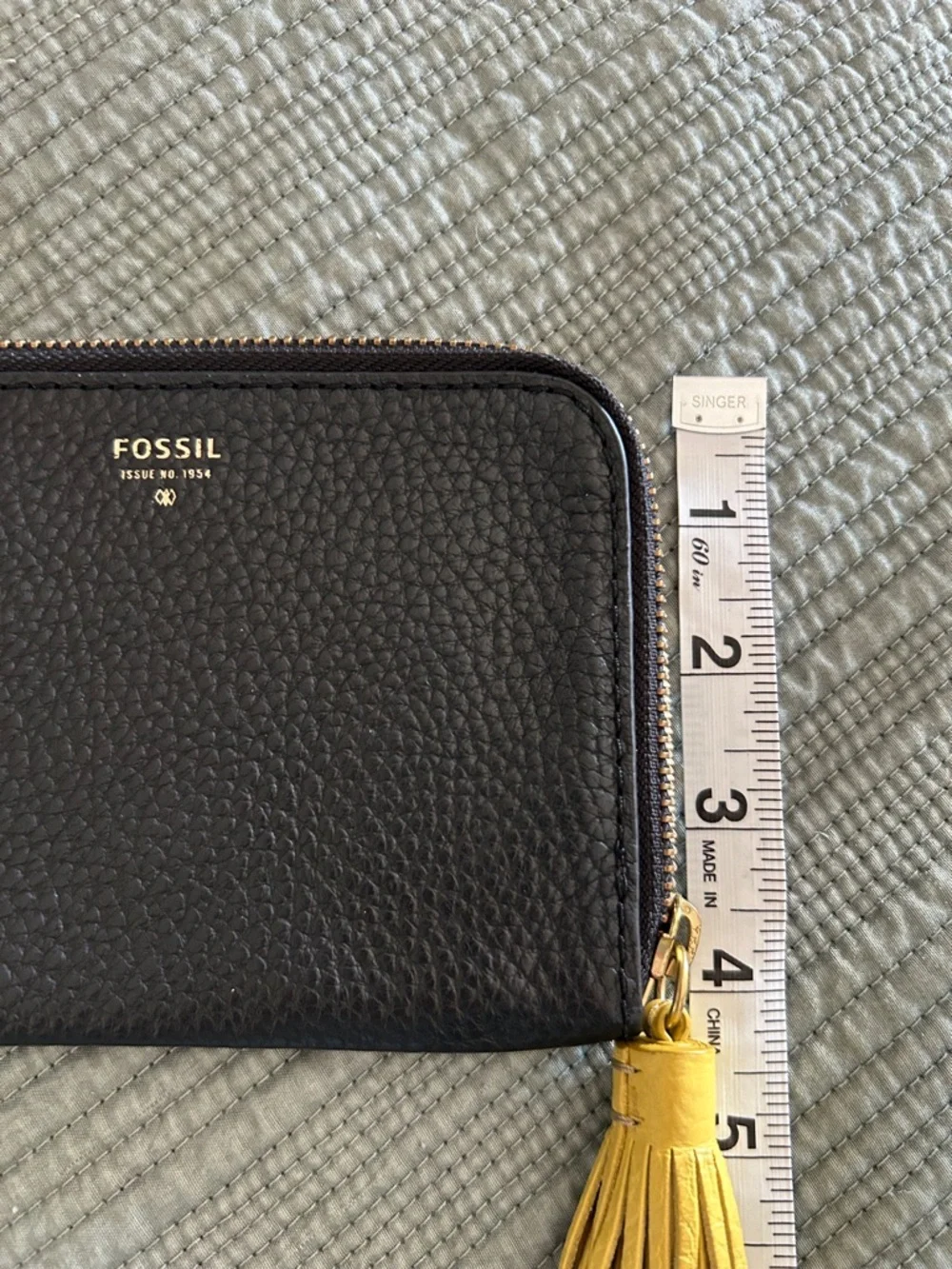 Fossil Tara Black Pebbled Leather Wristlet with Yellow Tassel Accent